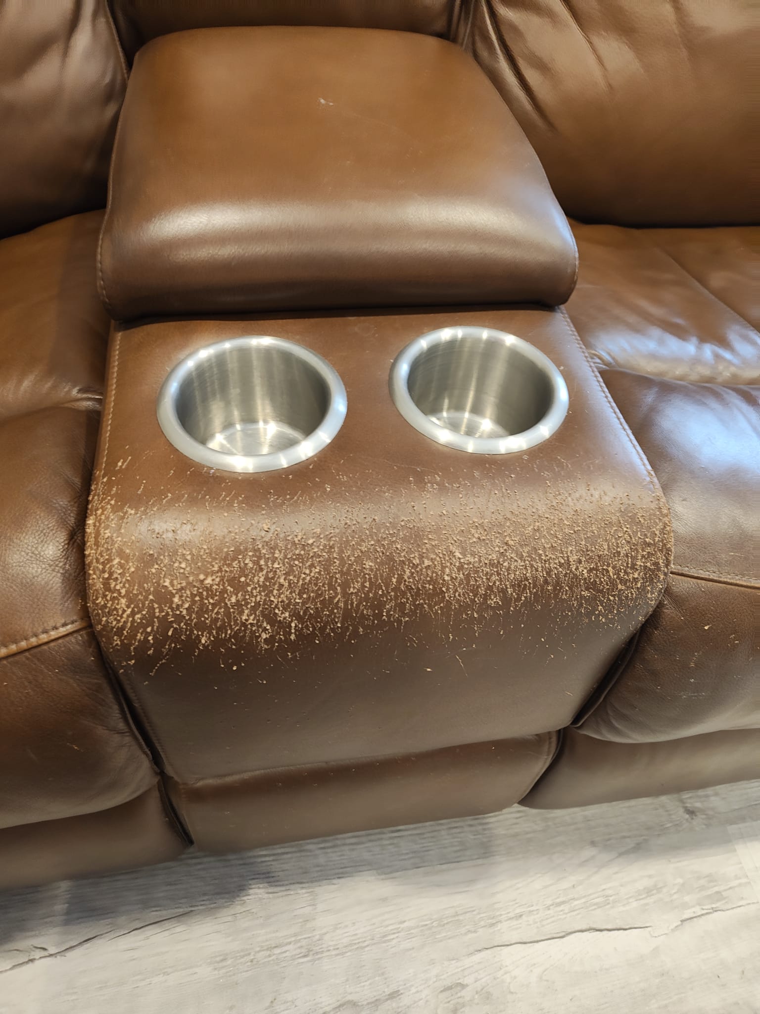 Damaged leather couch before restoration (center)